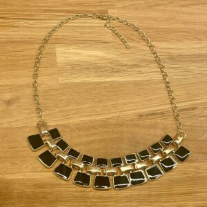Gunilla tufft halsband i guld och svart.